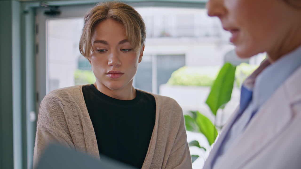 Woman patient listening doctor explanation at medical consultation closeup