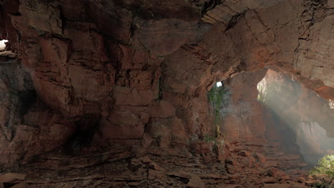 a ray of sunlight shines into the dark interior of a large cave