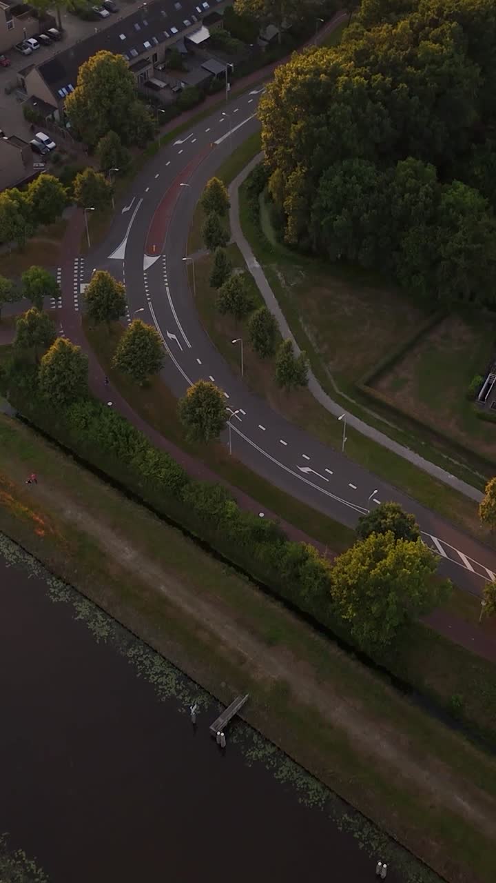 Aerial View of Suburban Road Intersection with Canal at Golden Hour