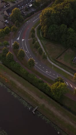 aerial view of suburban road intersection with canal at golden hour