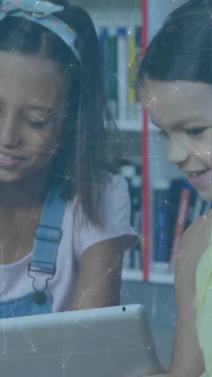 Vertical video: Students leaning at tablet on shelf, girl tapping, animated icons rising to learn