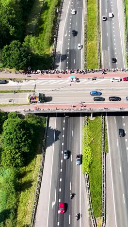 aerial view of a highway with an overpass crowded with spectators