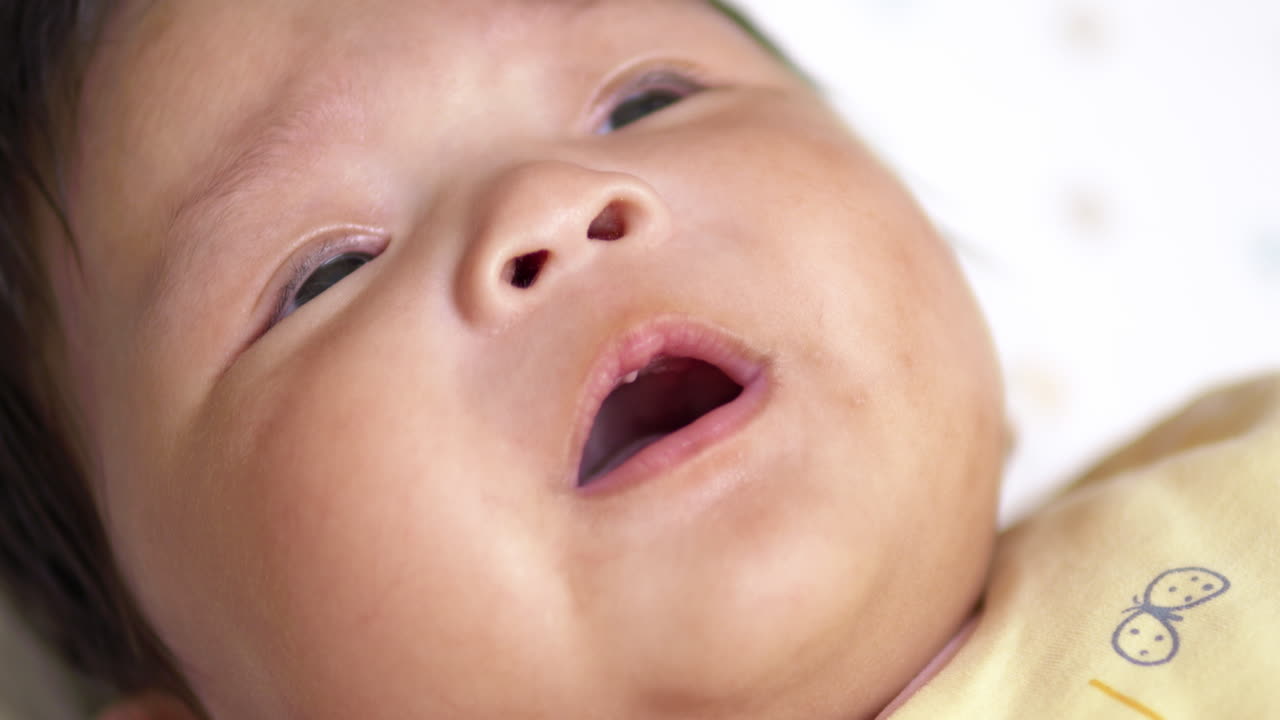 Curious Infant Girl Playing with Sounds to Communicate Emotions and Attract Attention, Showcasing Key Developmental Stages and Interactive Growth