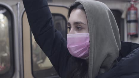 woman wearing a mask on a subway