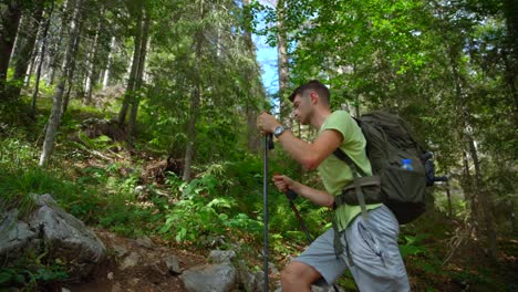 Man-hiking-in-the-forest-to-the-mountain