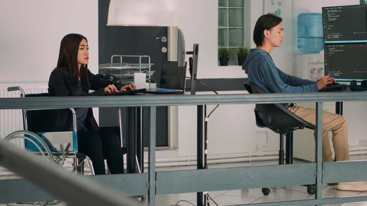 Database programer with physical disability writing code on computer screen