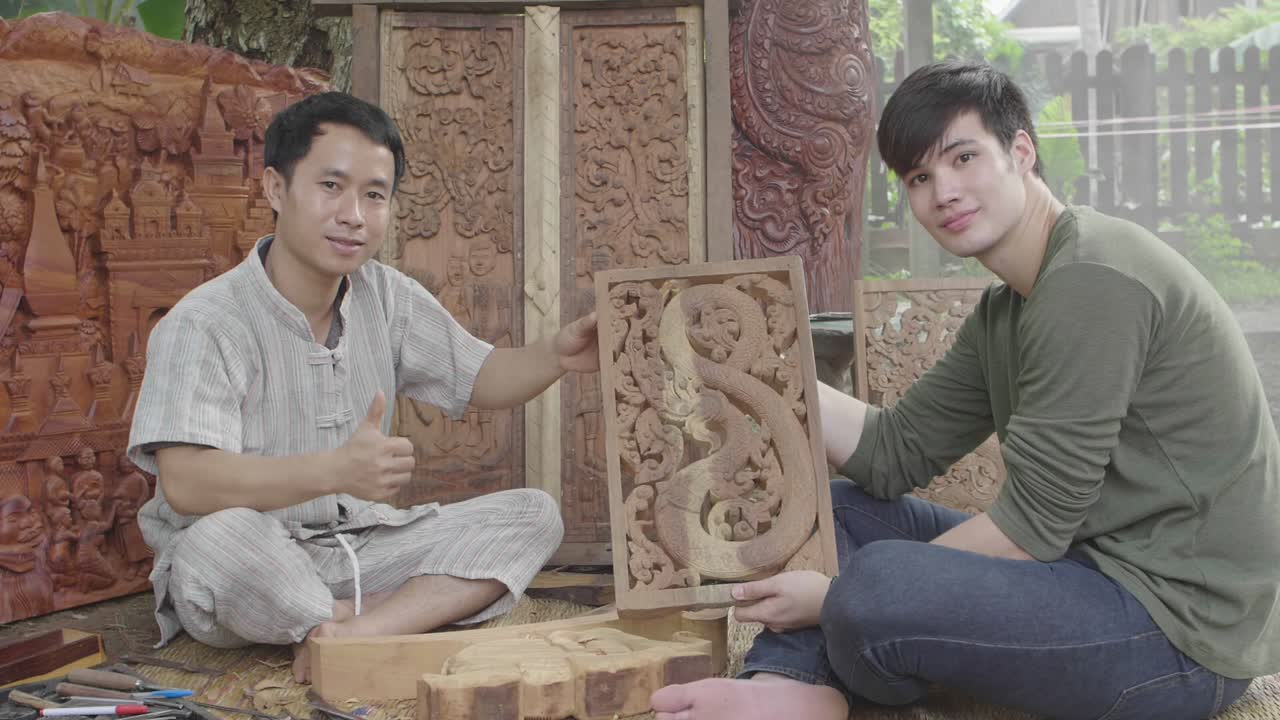 Asian Males Showing Carved Wood And Thumb Up, Slow Motion