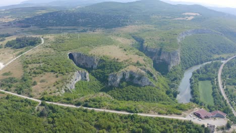 retreating drone shot of the panoramic view of prohodna cave, a geological park located in lukovit municipality, in karlukovo, bulgaria