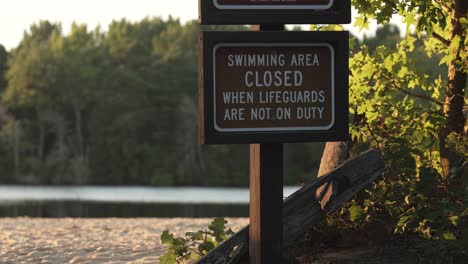 swimming area closed signpost on the shore of atsion lake in burlington county, new jersey, usa