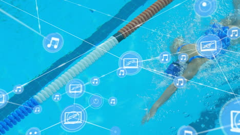 network of connection icons against female athlete swimming in the pool