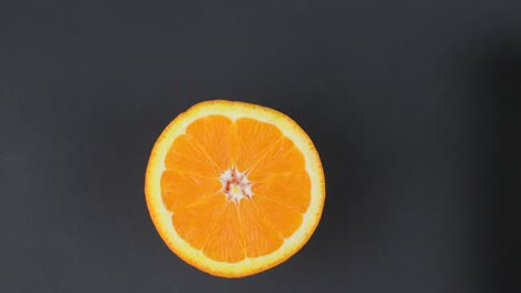 mitad de corte naranja girado sobre fondo negro. resolución 4k.