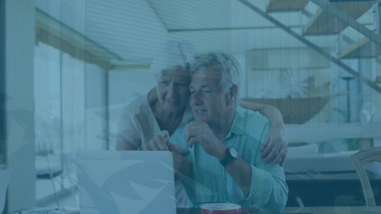 Animation of graphs over senior caucasian couple watching videos on laptop at home
