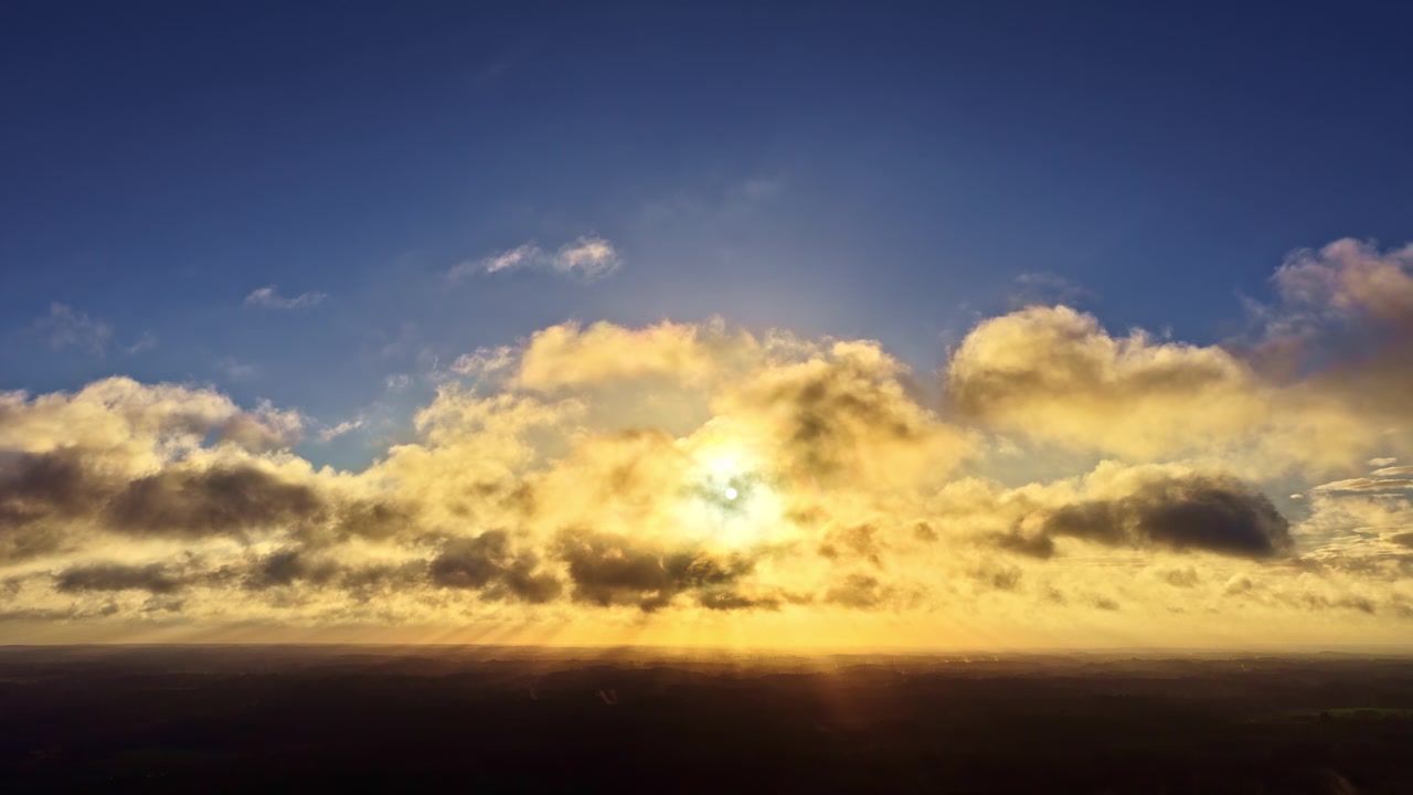 Beautiful natural sunset with silhouettes of horizon and stunning cloudy skies