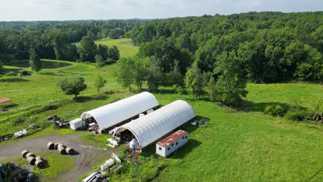 stunning aerial footage of a rural farm surrounded by lush greenery