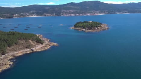 aerial view of illa de creba with mussel seafood farms in ria muros y noya galicia spain