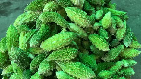 Pile-Of-Green-Bitter-Gourd-On-Ground-In-Market