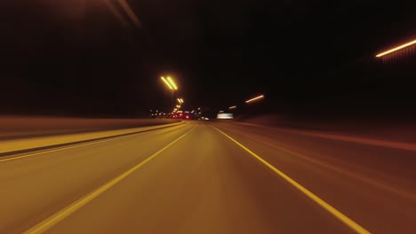 fast night hyperlapse: driving pov on dark highway, stopping in city