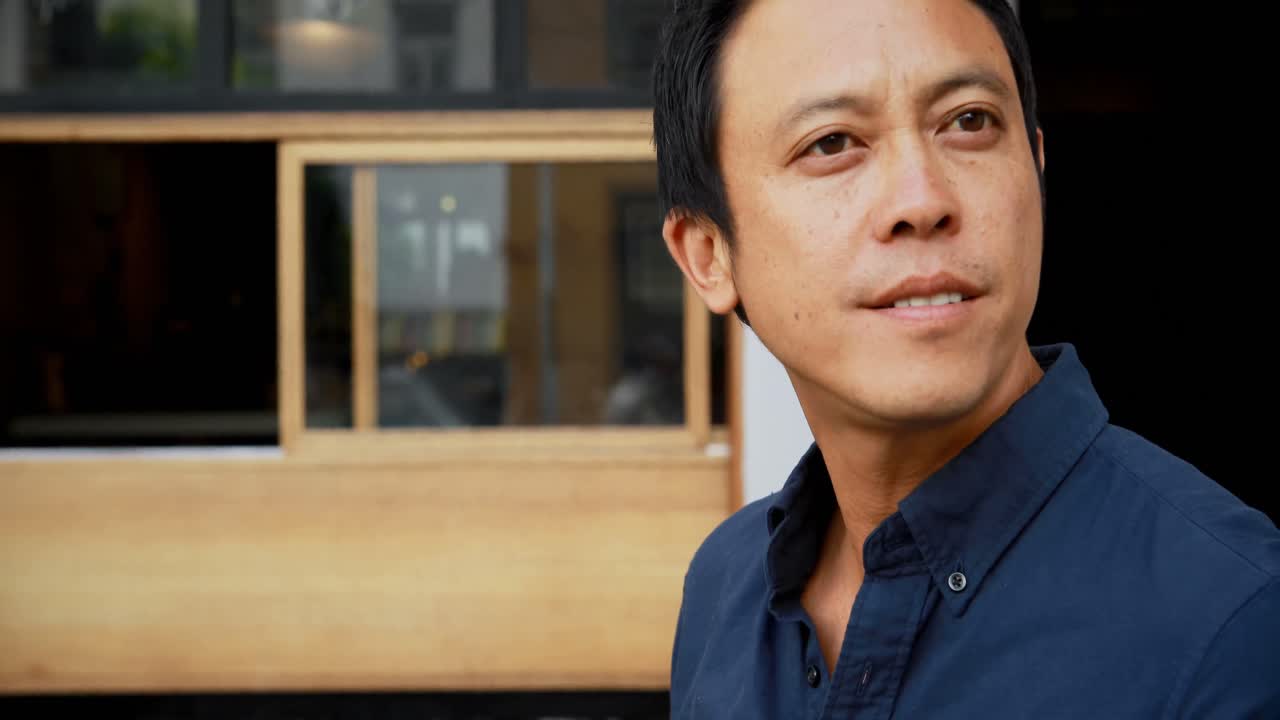 hombre sentado en una cafetería al aire libre 4k