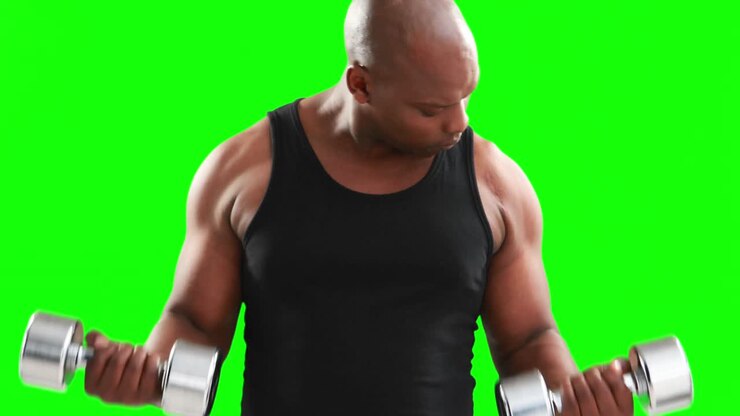 Serious muscular man lifting dumbbells