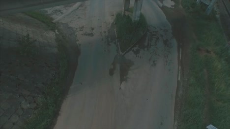 aerial view of road intersection under railway bridge