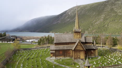 Exterior-Of-Lom-Stave-Church-In-Innlandet-County,-Norway---aerial-drone-shot