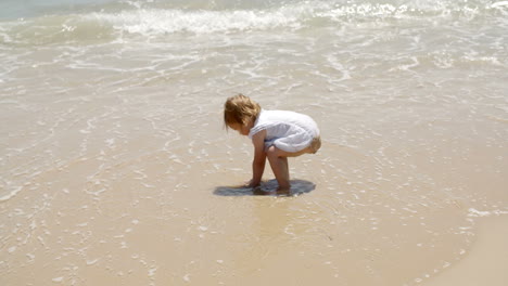 little girl playing in the sea