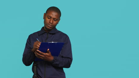 security guard holding clipboard, taking notes, receiving orders