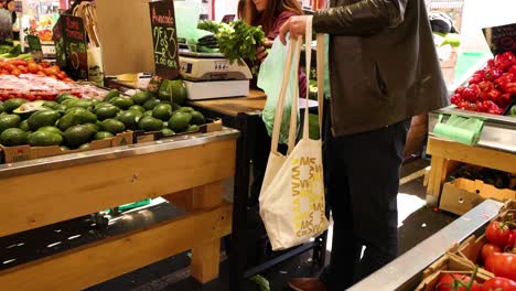 person selecting produce at a market stall