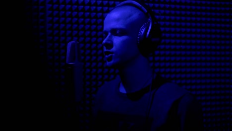 man recording vocals in a professional music studio