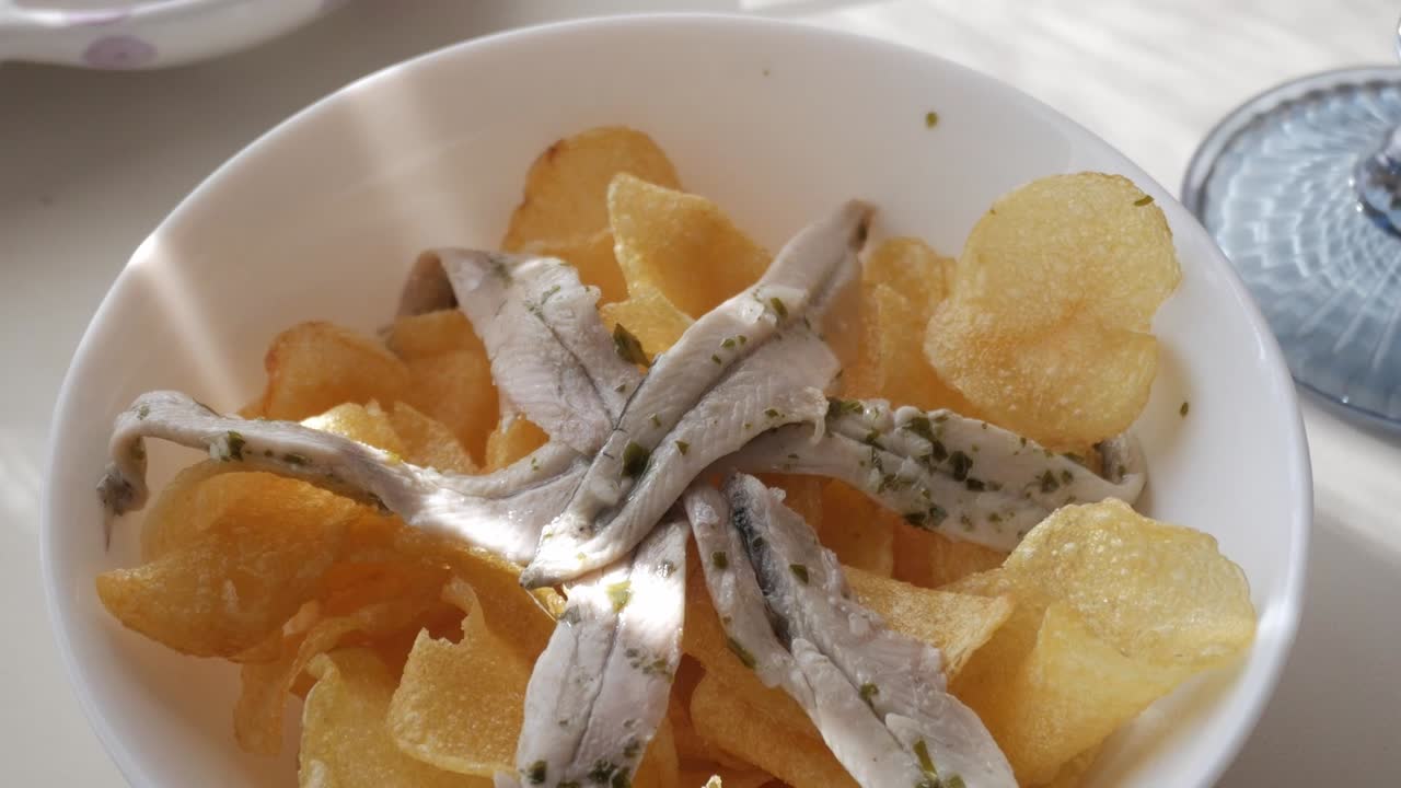 Delicious tapas featuring Gildas and boquerones on crispy potato chips