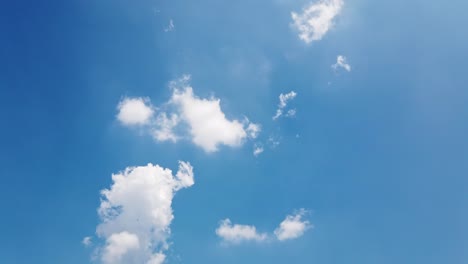 white puffy clouds and blue sky time-lapse with long second duration for background and graphics in daylight