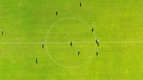 overhead aerial view of soccer football championship with player kicking the ball on centre mark