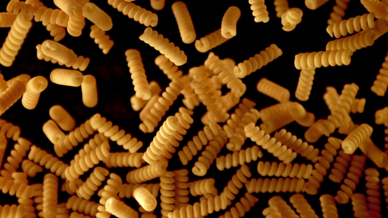 Uncooked Fusilli Pasta Falling in Super Slow Motion