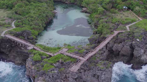 Wide-shot-of-the-famous-weekuri-lagoon-with-no-people-at-Sumba-Indonesia,-aerial