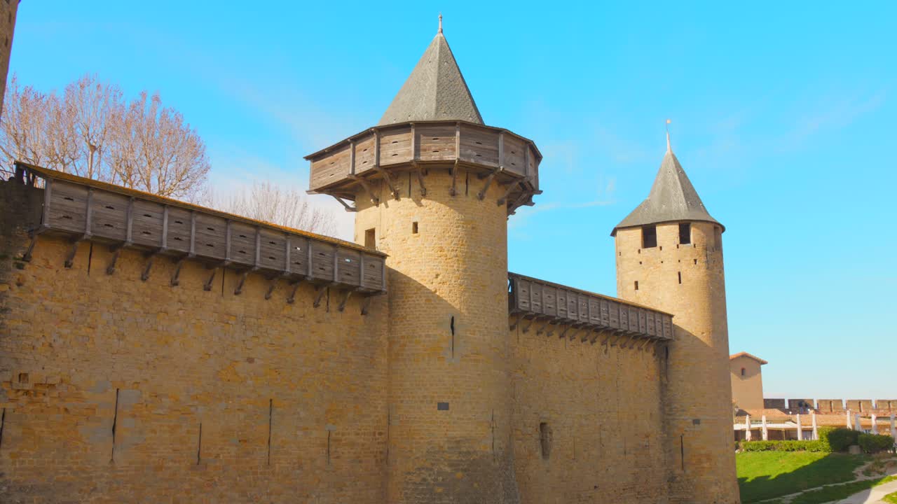 Experience the enchanting medieval castle and fortified city of Carcassonne in the South of France. Aerial and handheld views capture the intricate stone walls and towers on a sunny day.
