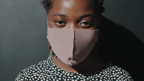 retrato de una mujer afroamericana con máscara facial en el estudio