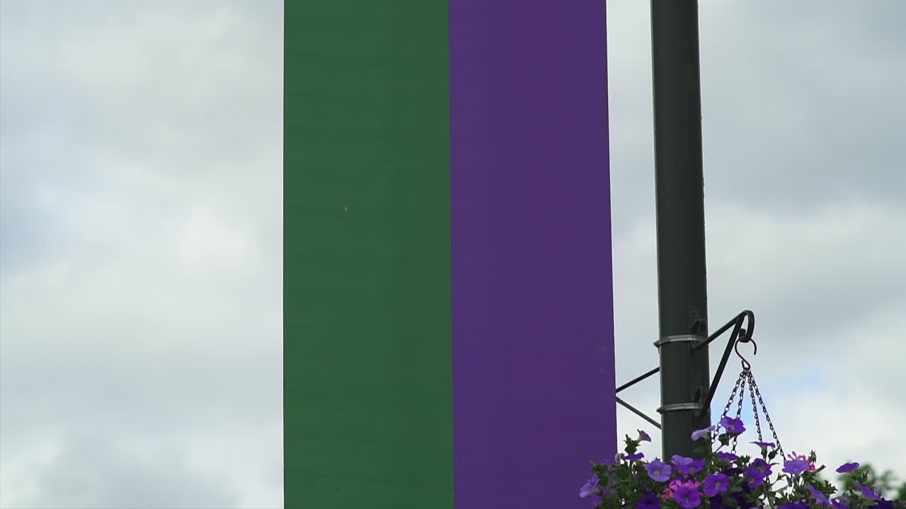 Wimbledon 2019: Wimbledon banner with logo blowing in the wind. Logo of the most famous tennis tournament in the world high on a pole.