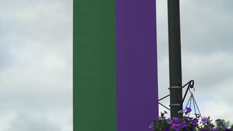 wimbledon 2019: wimbledon banner with logo blowing in the wind. logo of the most famous tennis tournament in the world high on a pole.