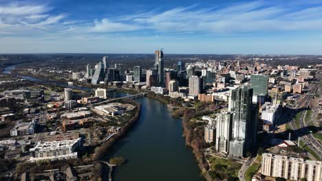 downtown austin and the colorado river, fall in sunny us - aerial, slow, approach