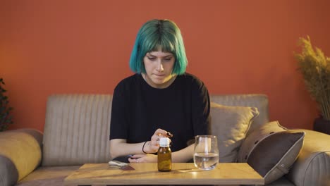 the young woman who looks at the pills in her hand and is going to commit suicide.