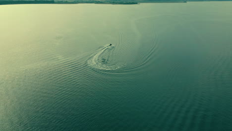 aerial view showing driving jet ski on endless sea in summer,slow motion shot