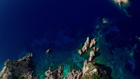 Top-down-aerial-drone-view-of-the-picturesque-rocky-coastline-of-Paleokastritsa-in-Corfu,-Greece