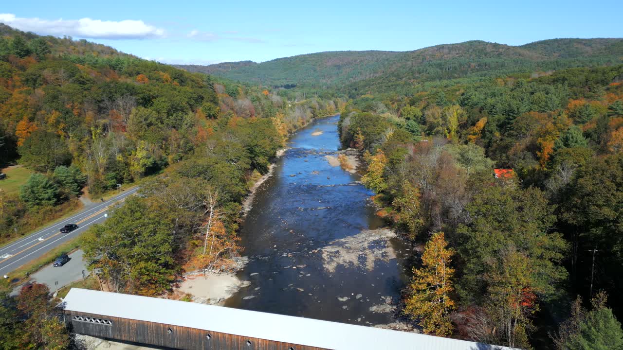 Aerial pullback reveal downstream of West River Covered Bridge, West Dummerston Vermont