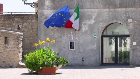 european and italian flags waving in the wind