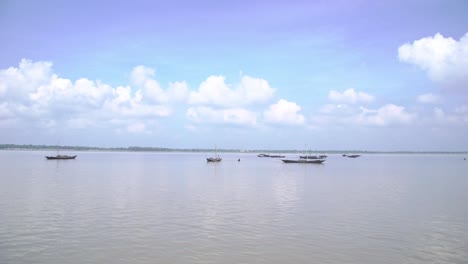 the boat is floating on the vast river in bengal