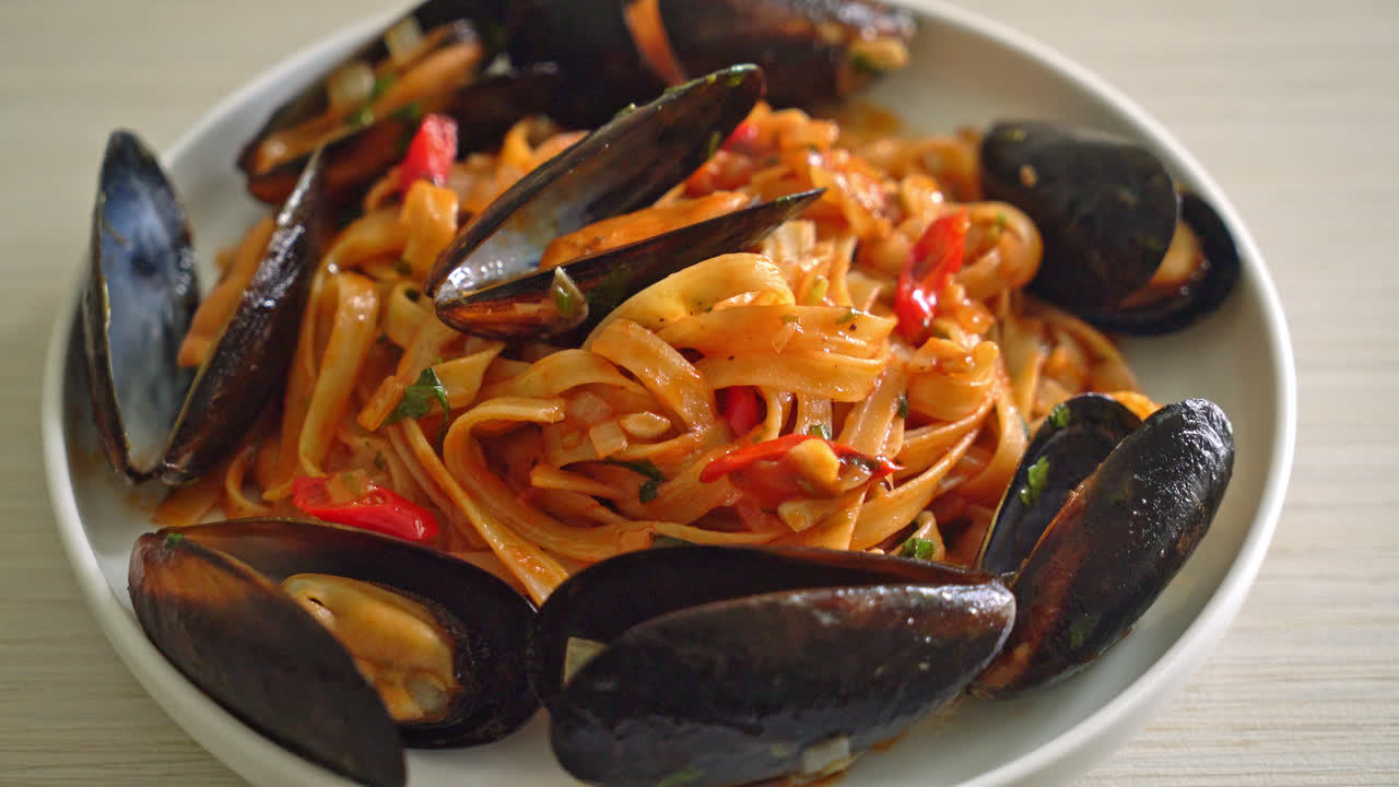 Spaghetti con cozze o vongole e salsa di pomodoro - Italian food style