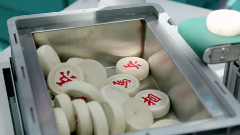 chinese chess pieces in a container