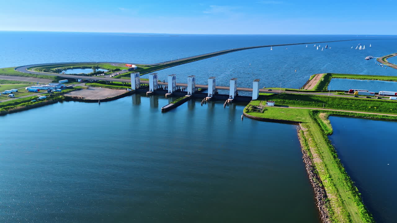 Approaching the sluices on the Merkemeer Lake. White sailboats on the waterscape at backdrop. Lelystad, the Netherlands.
