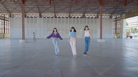 three friends rollerskating in an outdoor urban venue