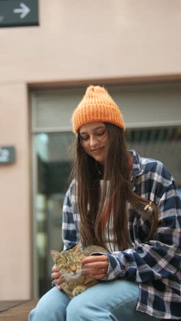 teenage girl cuddling a cat